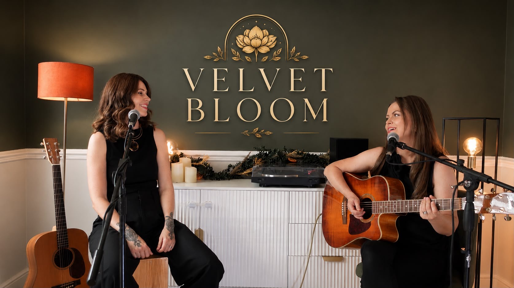 Velvet Bloom performing live, seated with acoustic guitar